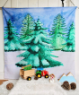 The Wondercloths Christmas Tree Play Cloth in a snowy play scene with the Bajo wooden tractor and Lanka Kade Christmas figures.