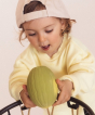 Toddler putting the Melon Oli & Carol 100% Natural Rubber Baby Sensory Ball  through a basketball hoop