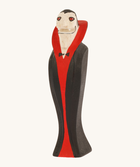 Bumbu Wooden Halloween Handmade and hand painted Vampire Toy, wearing a red and black cape, with a black bow tie on a cream background