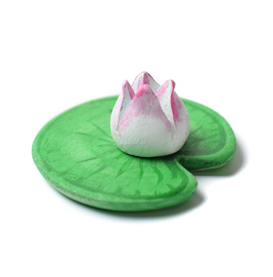 Close up of the Bumbu small handmade plastic free wooden water lily toy on a white background