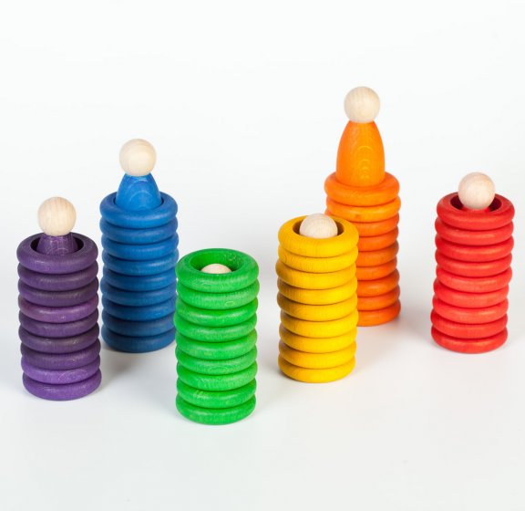 Grapat Nin Rings & Coins Wooden Toy Set. 6 rainbow coloured peg doll Nins, 36 rings and 18 coins for colour matching and sorting. Stacked in their corresponding colours on a white background.