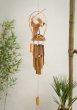 View of the back of the Namaste Bamboo Windchime with Nodding Bird decoration pictured hanging up with plants in the background 