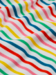 Close up of the Frugi rainbow stripe organic cotton baby body suit 