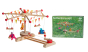 Kraul Wooden Swing Roundabout Kit with passenger dolls next to product box