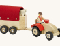 Ostheimer wooden horse box with red roof, showing horses inside the horse box and being pulled by a wooden farmer figure on a wooden tractor