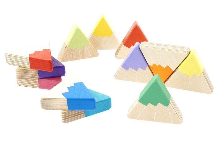 Hellion Toys sustainable handmade rainbow mountain toys scattered on a white background
