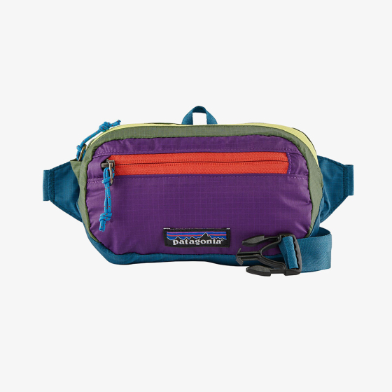 Patagonia ultralight black hole mini hip pack in patchwork and Steller blue.