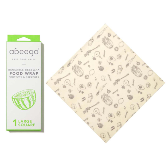 Abeego large square natural beeswax food wrap on a white background next to its packaging