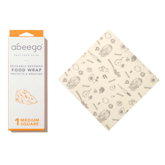 Abeego medium square beeswax food wrap laid out on a white background next to its packaging