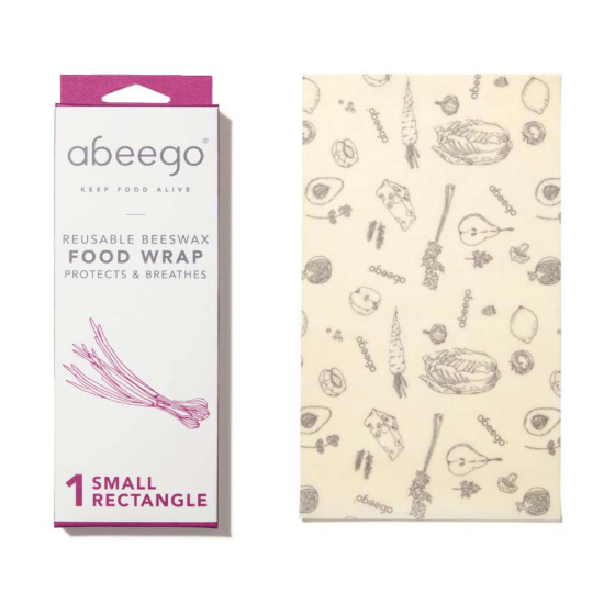 Abeego small rectangle natural beeswax food wrap laid out on a white background next to its packaging
