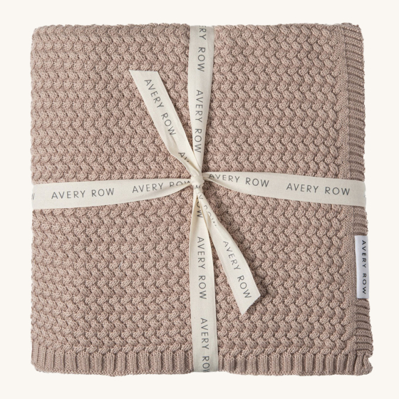 Avery Row Plait Knit Baby Blanket - Dusty Pink, a lilac pink chunky knit blanket tied with an Avery Row ribbon