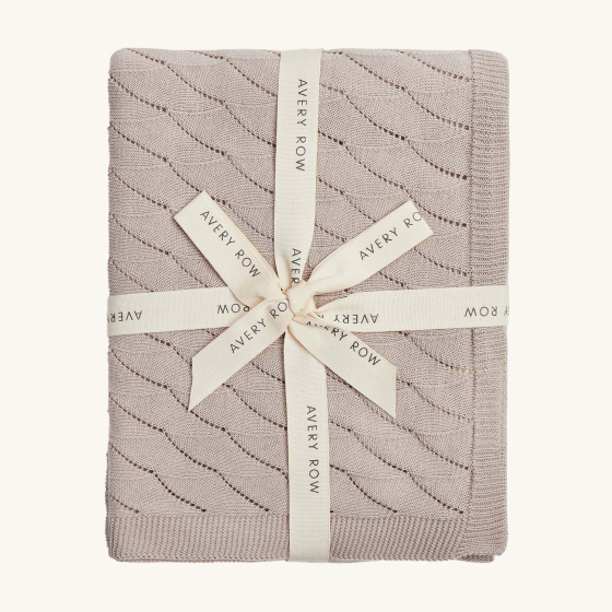 Avery Row Wave Kit Baby Blanket - Mist. A beautiful and delicate wave knit patterned blanket in a light grey colour, wrapped up in a branded Avery Row ribbon.
