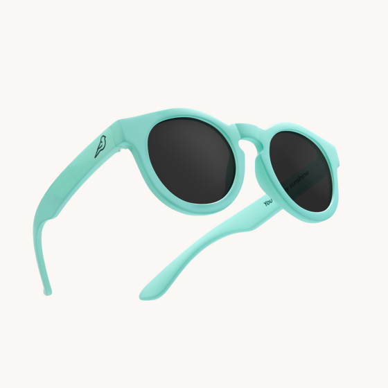 Bird plant based eco-friendly childrens sunglasses in the sky blue colour on a cream background