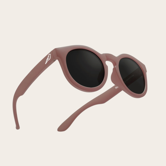 Bird Eyewear Kid's Birdies Sunglasses - Coral. 100% UV protection to UV400 sunglasses on a cream background