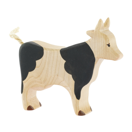 Bumbu childrens handmade black and white wooden cow toy on a white background
