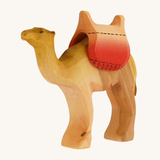 Bumbu Handmade Wooden Camel Saddle on the back of the Bumbu wooden camel, on a cream background