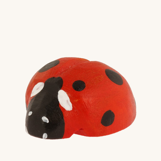 Bumbu Wooden Ladybug, painted red with black and white spots and on a cream background