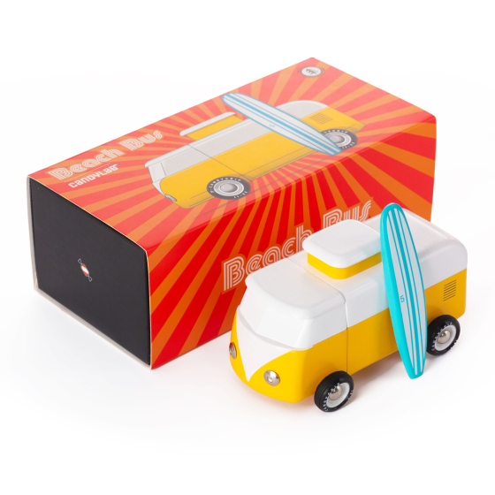 Candylab kids wooden campervan toy with a magnetic surfboard on a white background next to its box