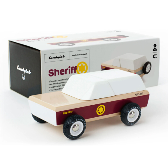 Candylab Lone Sheriff wooden toy car, a vintage sheriffs car with burgundy stripe and yellow sherifs star, spare wheel on the rear. On a white background stood in front of box