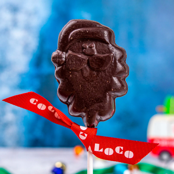 Close up of the Cocoa loco fairtrade dark chocolate santa lolly on a blue blurred background
