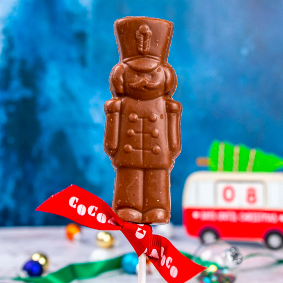 Close up of the Cocoa loco fairtrade milk chocolate soldier lolly on a blue blurred background