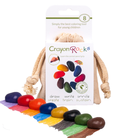 Crayon Rocks 8 natural soy wax crayon set on a white background next to their cotton muslin bag