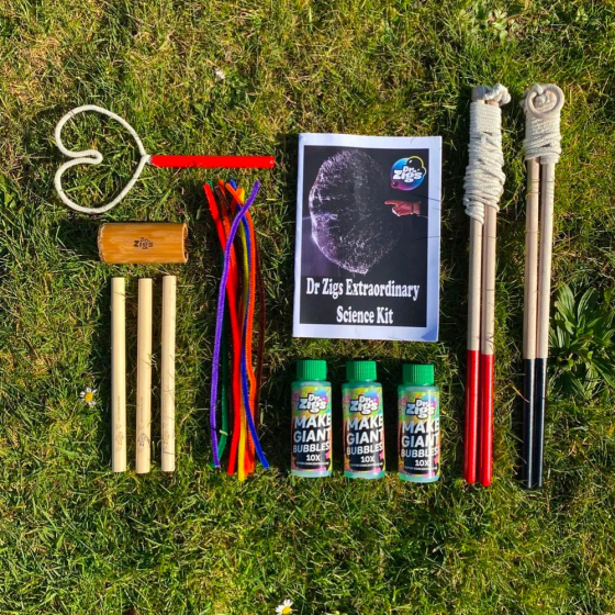 Dr Zigs eco-friendly bubble science kit laid out on some grass