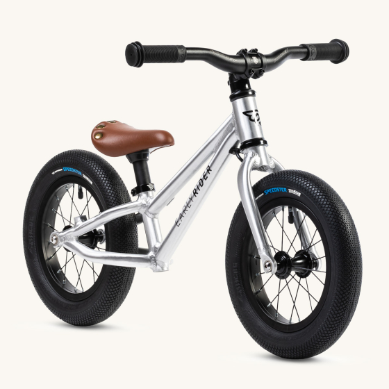 Early rider kids charger 12 inch balance bike on a beige background