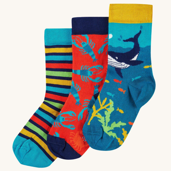Frugi Rock My Socks 3-Pack - Deep Water, made from GOTS organic Cotton. A three pack of socks with comfy rib cuff, featuring fun Frugi designs that compliment the clothing ranges. On the left the socks design is yellow, light blue, red and green stripe, t