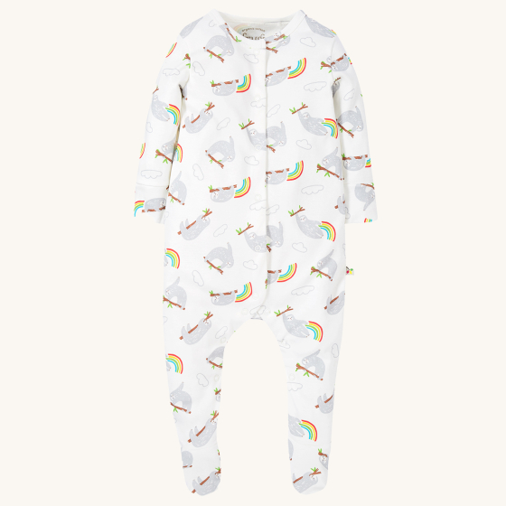 Frugi Baby Organic Cotton Lovely Babygrow - Sleepy Sloths. A footed babygrow imade from super soft organic cotton and features adorable sleepy sloths and rainbows all-over print, on a cream background