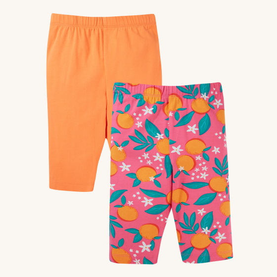 Frugi Organic Cotton Laurie Shorts Orange Blossom/Tangerine - 2 Pack. Two pairs of bright, colourful shorts. The one in the back is a bright orange colour, and the one in front is pink with oranges and orange blossom print. On a cream background