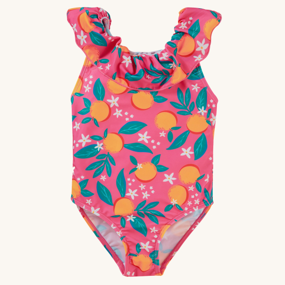 The front of the Frugi Amelia Swimsuit - Orange Blossom swimsuit made with Recycled material and soft lining with ruffle detail. A fun orange blossom print on pink material, on a cream background.