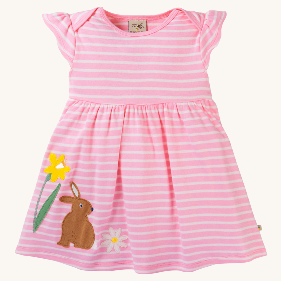 Frugi Bobby Dress - Jellyfish Breton / Rabbit. Made with GOTS Organic Cotton, this is a cheerful pink and white stripe dress, with a rabbit, daffodil and white daisy flower applique on the bottom of the dress, on a cream background 