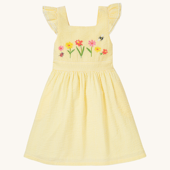 The front of the Frugi Jasmine Dress - Flowers made from GOTS Organic cotton. A light sunshine, yellow and white striped short sleeve dress with adjustable ruffle straps, smocked back, and a gathered waist with waste band. This dress features carefully em