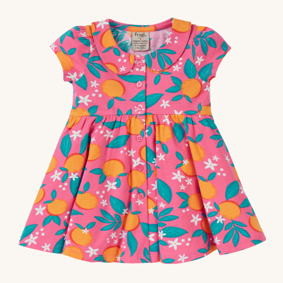 Frugi Organic Lettie Dress - Orange Blossom. A beautiful pink soft, organic cotton, short sleeve dress with an all over orange and orange blossom print, with a peter pan collar, twirly skirt and buttons down the front. On a cream background