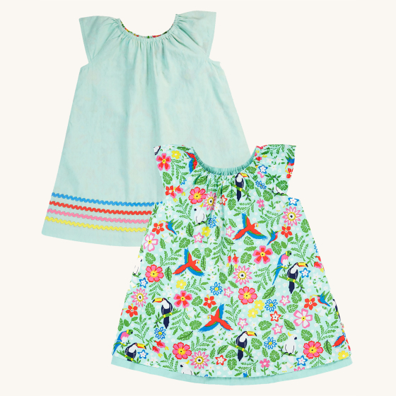 Frugi Children's Organic Cotton Lowen Reversible Dress - Tropical Birds / Spring Dobby. A beautiful reversible dress with one side showing tropical bird and flower print, and the other side a light mint green with blue, red, pink and yellow wavy hem detai