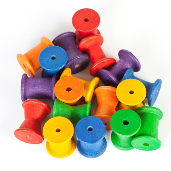 Grapat Wooden Spools 18 - Rainbow Reels for heuristic play. Stack, sort, colour match and count with these rainbow coloured wooden toy reels. Mixed colours on a white background. 