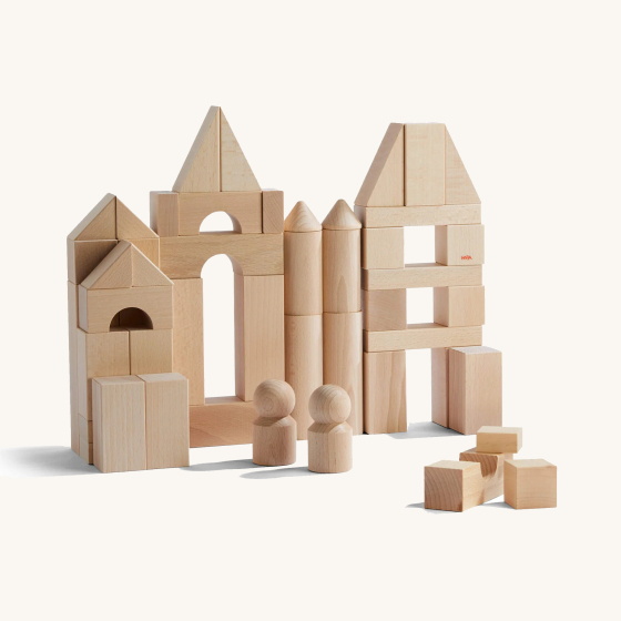 HABA Wooden Building Blocks Starter Set - Large. Natural Wooden blocks in various shapes and sizes on a cream background