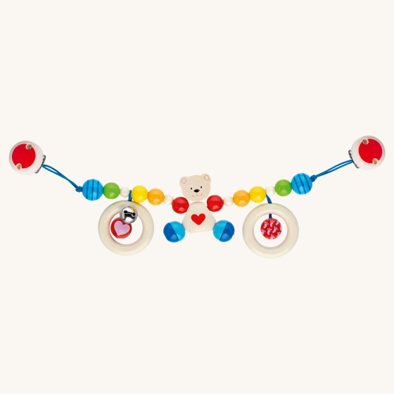 Heimess natural wooden baby pram teether chain with the heart bear design on a beige background