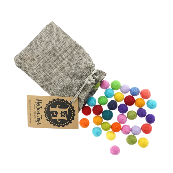 Hellion Toys eco-friendly natural merino woollen balls pouring out of a grey bag on a white background