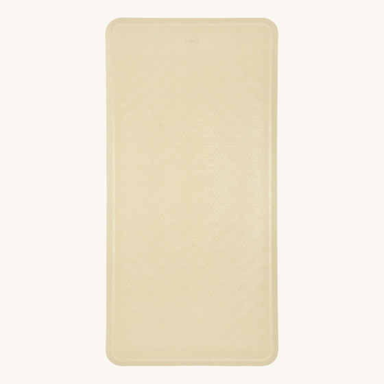Hevea natural rubber bath mat in the sand colour on a beige background
