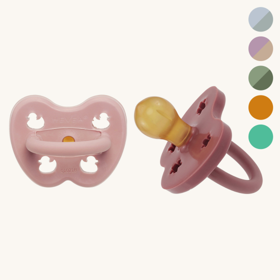 Hevea natural rubber round pacifiers on a beige background