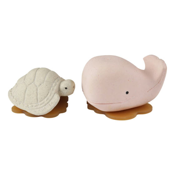 A picture of the Hevea Squeeze'n'splash Whale & Turtle rubber Bath toys in Champagne Pink and Vanilla, sat facing each other with a white background