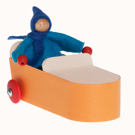 Small blue felt doll sat in the Kraul Wendolin Gravity Car.