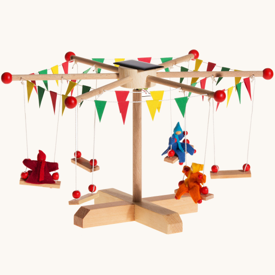 Kraul Solar Carousel Kit showing construction and dolls on the carousel swings