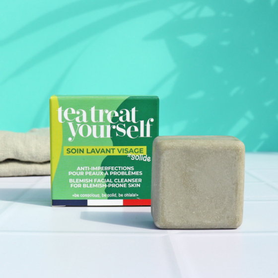 Picture of the Lamazuna Tea Treat Yourself Blemish Prone Skin Cleansing Bar with its green box, on a teal background.