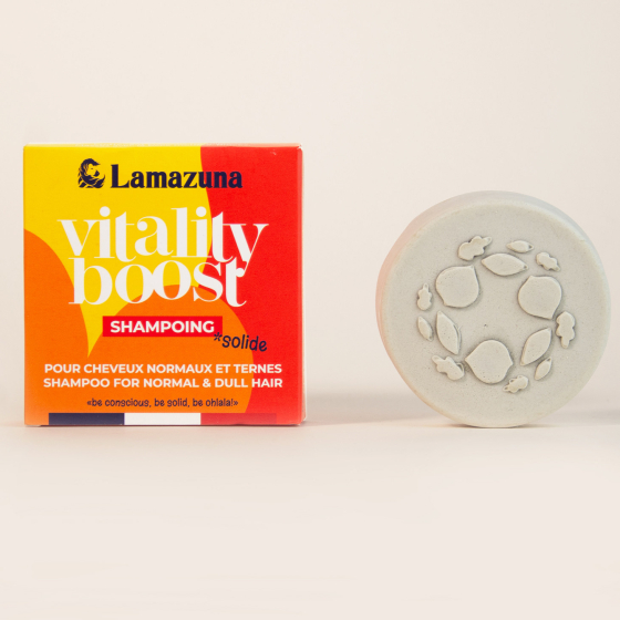 Picture of the Lamazuna Vitality Boost solid shampoo for normal and dull hair, next to its orange and yellow box.