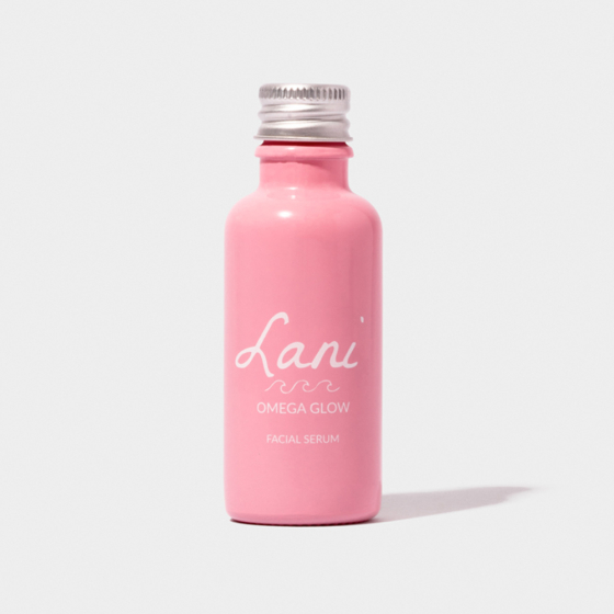 Lani Omega Glow Facial Serum vegan, plastic free and cruelty free beauty. Pink bottle on a blue background