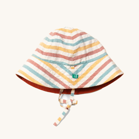 Little Green Radicals Walnut Striped Reversible Sun Hat. A beautiful reversible sunhat made with GOTS Organic Cotton with rainbow stripes and a tie that fastens under the chin, on a cream background
