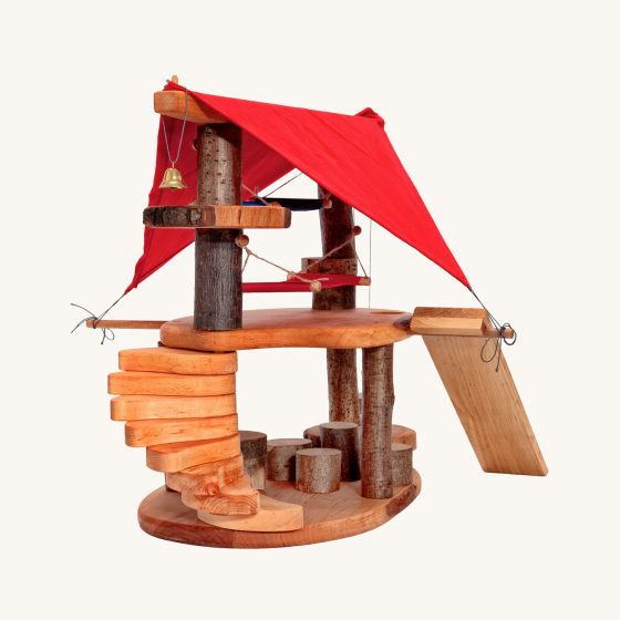 Magic Wood Gnome Home. A beautifully crafted Gnome Home made with real and natural wood parts and brought to life with little fabric hammocks, a red fabric roof and a small golden bell, on a cream background